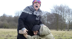 King Lear photo: actors cowering in field