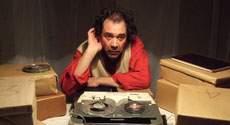 Krapps Last Tape photo: actor sitting at a table with a tape recorder