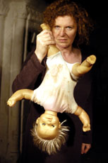 Macbeth photo: actress holding a doll upside down