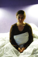 Ratman photo: actor sitting on bed